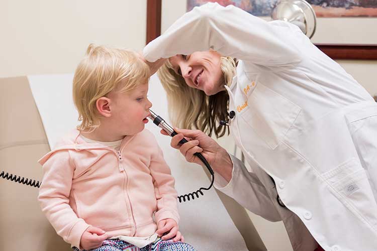 Ohio Urgent Care physician examining toddler